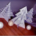 árbol de Navidad haciendo cortes a un papel