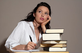 Woman sitting at her desk thinking of things to write