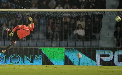 Real Madrid goalkeeper Adan fails to save a goal from Celta player Cristian Bustos