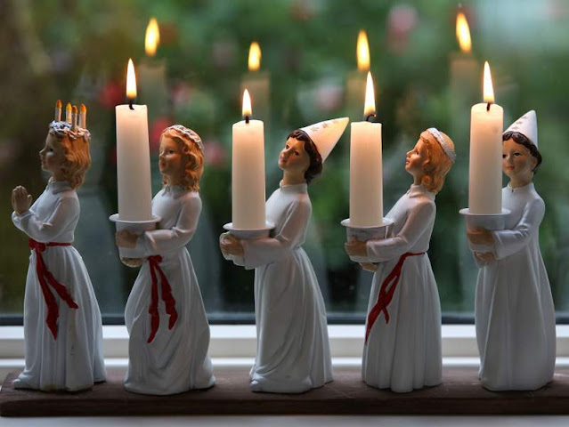 Figurines of young women holding the candles of St Luica's day