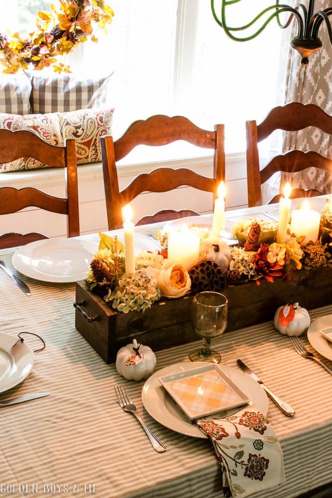DIY wooden box centerpiece with flowers, pumkins and candles in fall dining room