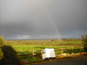 A rainbow somewhat brightens up a dark Irish sky - we just don't see it