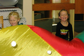 children playing with a parachute and balls