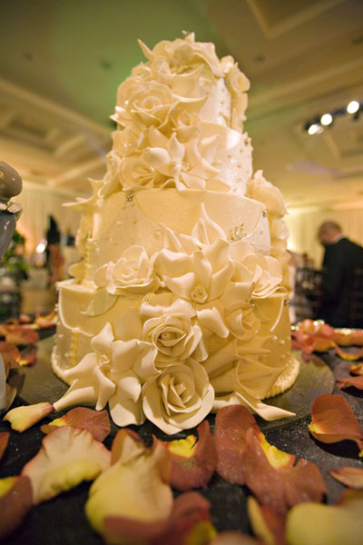 Amazing round 4 tier wedding cake encrusted with lovely white sugar roses