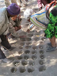 Mancala Oware is an ancient math skills African game. Mankala board dug into the ground Mancala Oware is an ancient math skills African game.