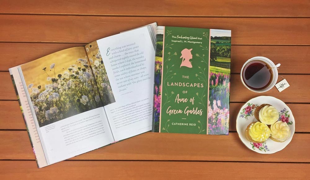 Photograph of The Landscapes of Anne of Green Gables by Catherine Reid with a cup of tea and cupcakes