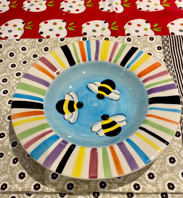 colorful bowl with bee figures in the center