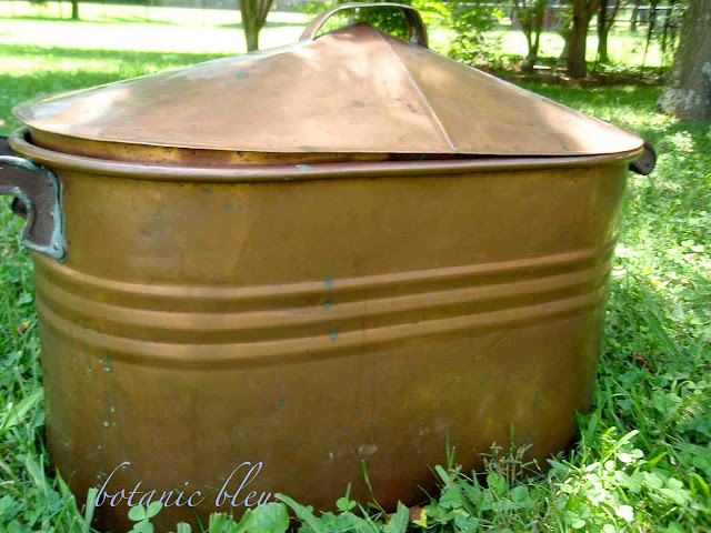 Antique copper pot with lid is perfect for hydrangeas in summer and firewood in winter