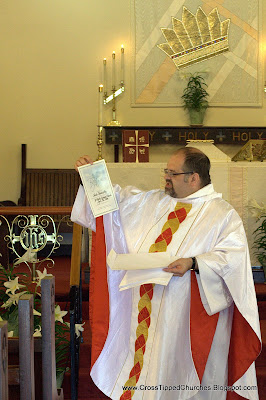 Priest passing out certificates.