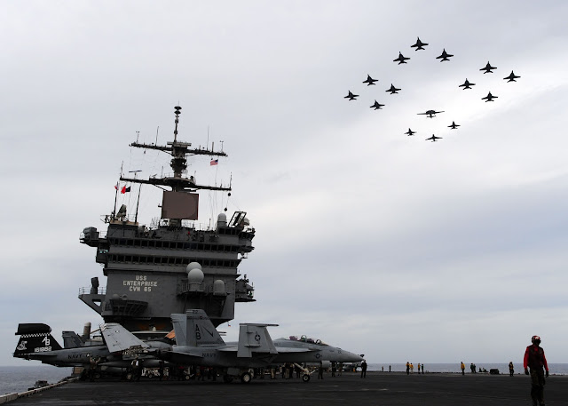 Aircraft assigned to Carrier Air Wing (CVW) 1 fly in formation over the aircraft carrier USS Enterprise (CVN 65)