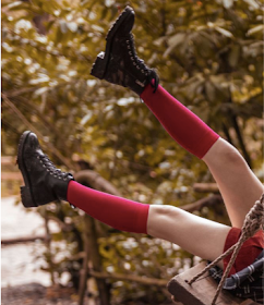 SockShop red socks on a girl on a swing