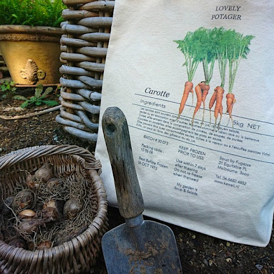 A carrot-like canvas tote bag harvested from Peter Rabbit's vegetable garden is perfect for gardening.