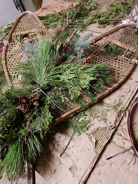 Vintage snowshoes with greenery