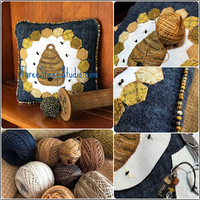 A Bee Skep surrounded by golden yellow honeycomb and a smattering of bees - 'The Hive' punch needle and wool applique pattern by Rose Clay at ThreeSheepStudio.com