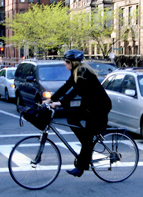 blonde in black on a bike Boston