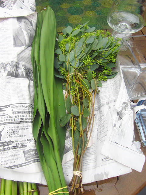 bouquet of Tea leaves and seeded eucalyptus on an outdoor patio table