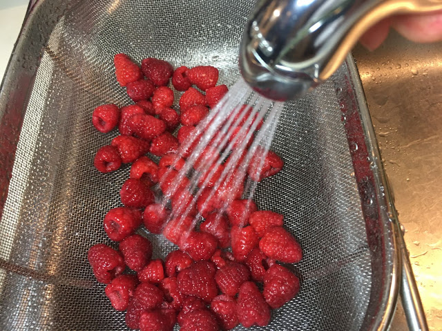 Gently rinsing the berries after the saltwater bath