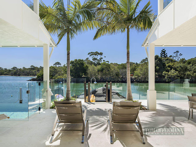 Photo of garden furniture on the balcony by the water