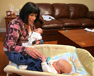 Image: Robin Brussel holds her 5-week-old son, Noah Brussel, as she checks on her 4-month-old granddaughter, Joey Fowler Holmes. Robin was caring for the pair at her home in Labadie