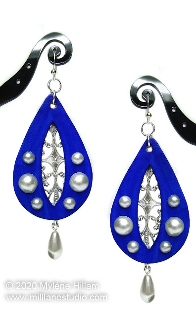 Ultramarine blue leather teardrop earrings with cut out for filigree and imitation pearl detailing.