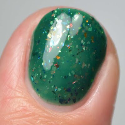 green nail polish with flakies close up swatch