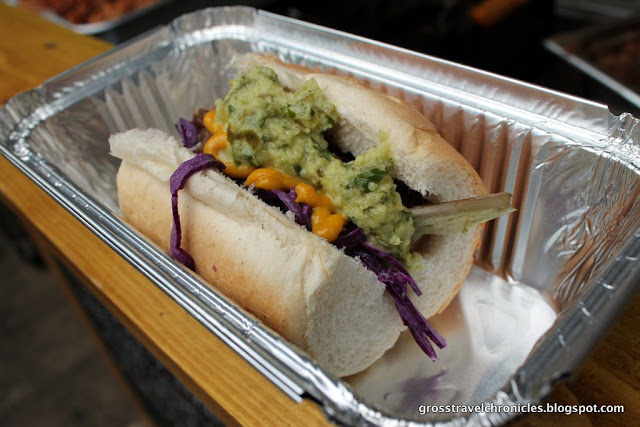 sausage in a roll with toppings