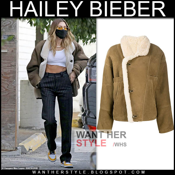 Hailey Bieber in brown leather jacket and white crop top