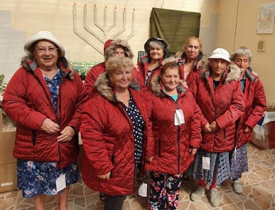 Holocaust Survivors wearing winter coats