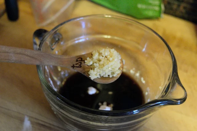 Garlic being added to the mixing bowl.