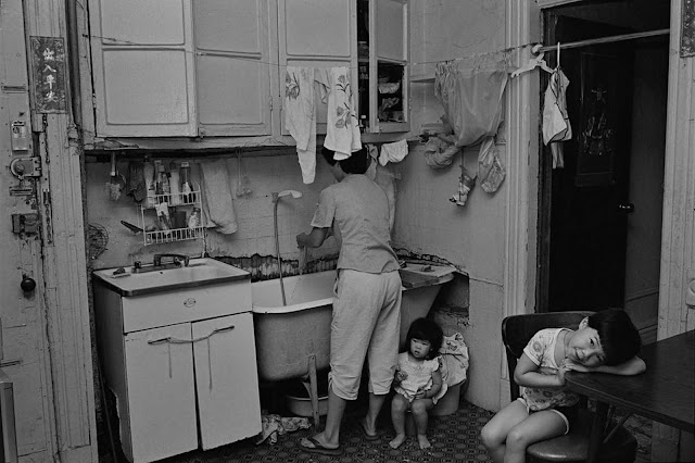 Rebecca with her children in their kitchen, 1982.
