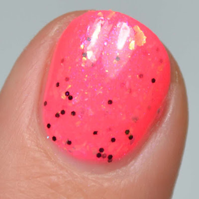 neon pink nail polish with flakies swatch