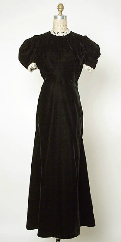 Black evening gown displayed on mannequin. Design by Jacques Fath 1937-1939