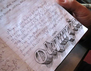 The word Olympia hand lettered in 3D with shadows