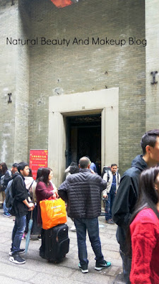 Entrance of Lou Kau Mansion near Cathedral Square, Macau. Showing visitors and the gate