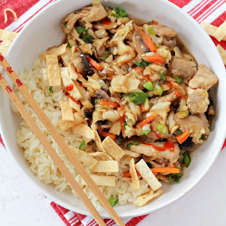 quick and easy pork and cabbage stir fry bowl overhead view with chops sticks
