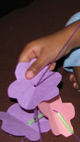 Fine motor skills - Thread straw and paper flowers to make a lei