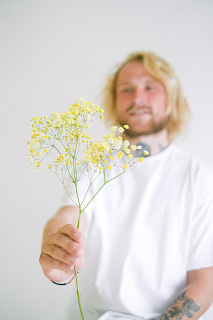 man holding baby's breath stem