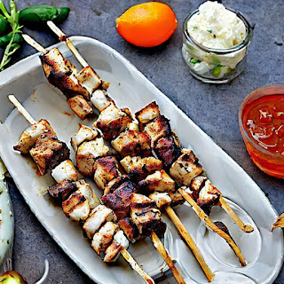 Grilled skewered meat, often served with pita bread, tzatziki, and fresh vegetables.