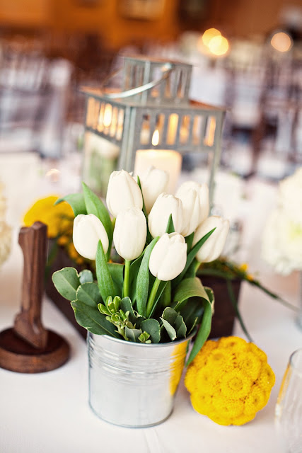 Each table featured one rustic wooden box with a metallic silver lantern