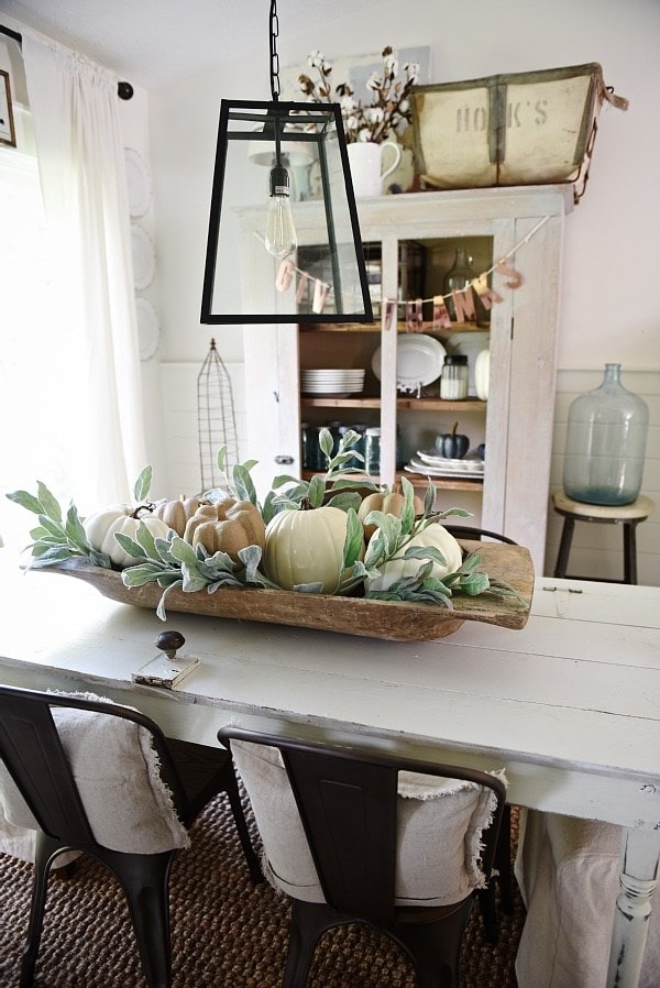 rustic farmhouse dining room decor for fall - how to decorate with a rustic antique bread bowl and pumpkins