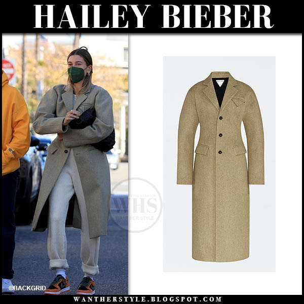 Hailey Bieber in beige coat and orange sneakers