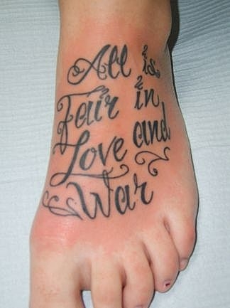 Lettering tattoos on the side of the foot