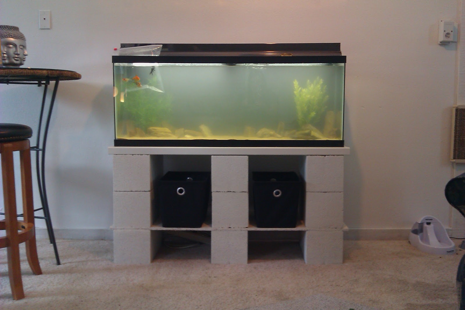 added two storage bins to the shelves to hold fish food and supplies 