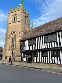 Shakespeare's schoolroom, which is a black and white striped Tudor building.