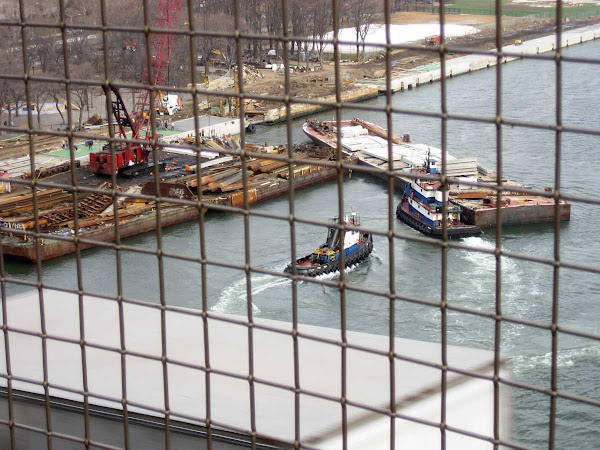 East River Tugs - Pushing a barge on the Manhattan shore, from the Williamsburg Bridge.