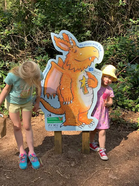 Sisters posing next to a picture of Zog at the end of Thetford Forest Zog trail