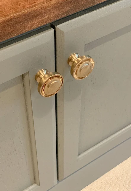 brass knobs on gray cabinets