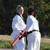 Two girl black belt taekwondo instructors teaching kids martial arts classes