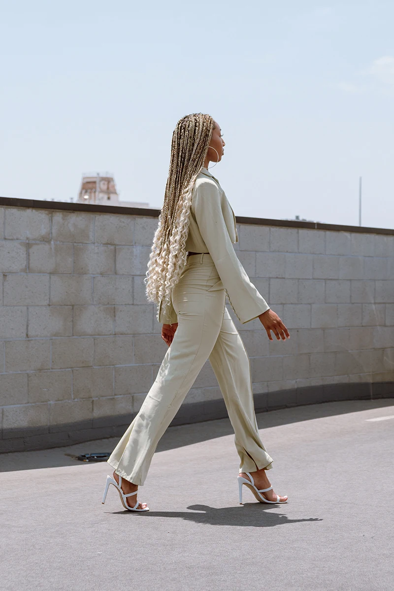 stylish woman in an off-white linen suite