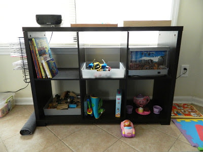 Close-up of wood bookcase with books and toys